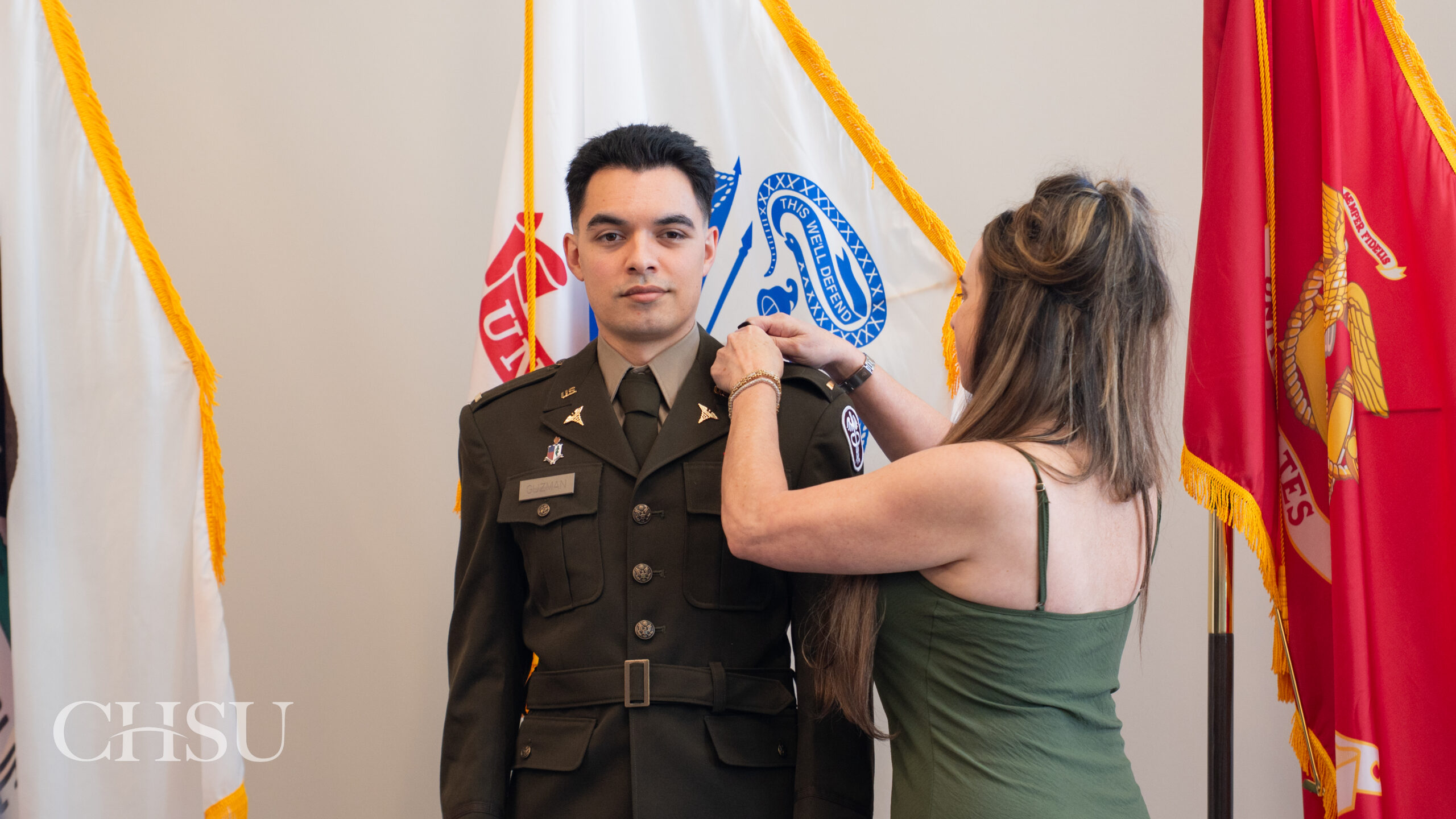 military officer medical graduate having uniform pinned with new rank