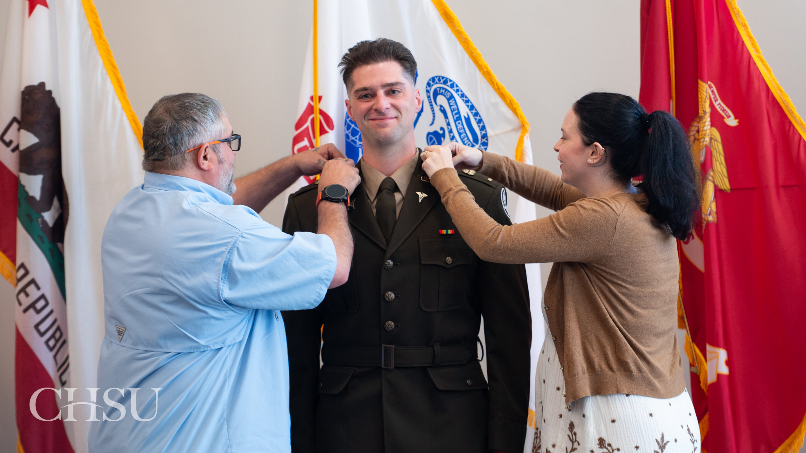 military officer medical graduate having uniform pinned with new rank