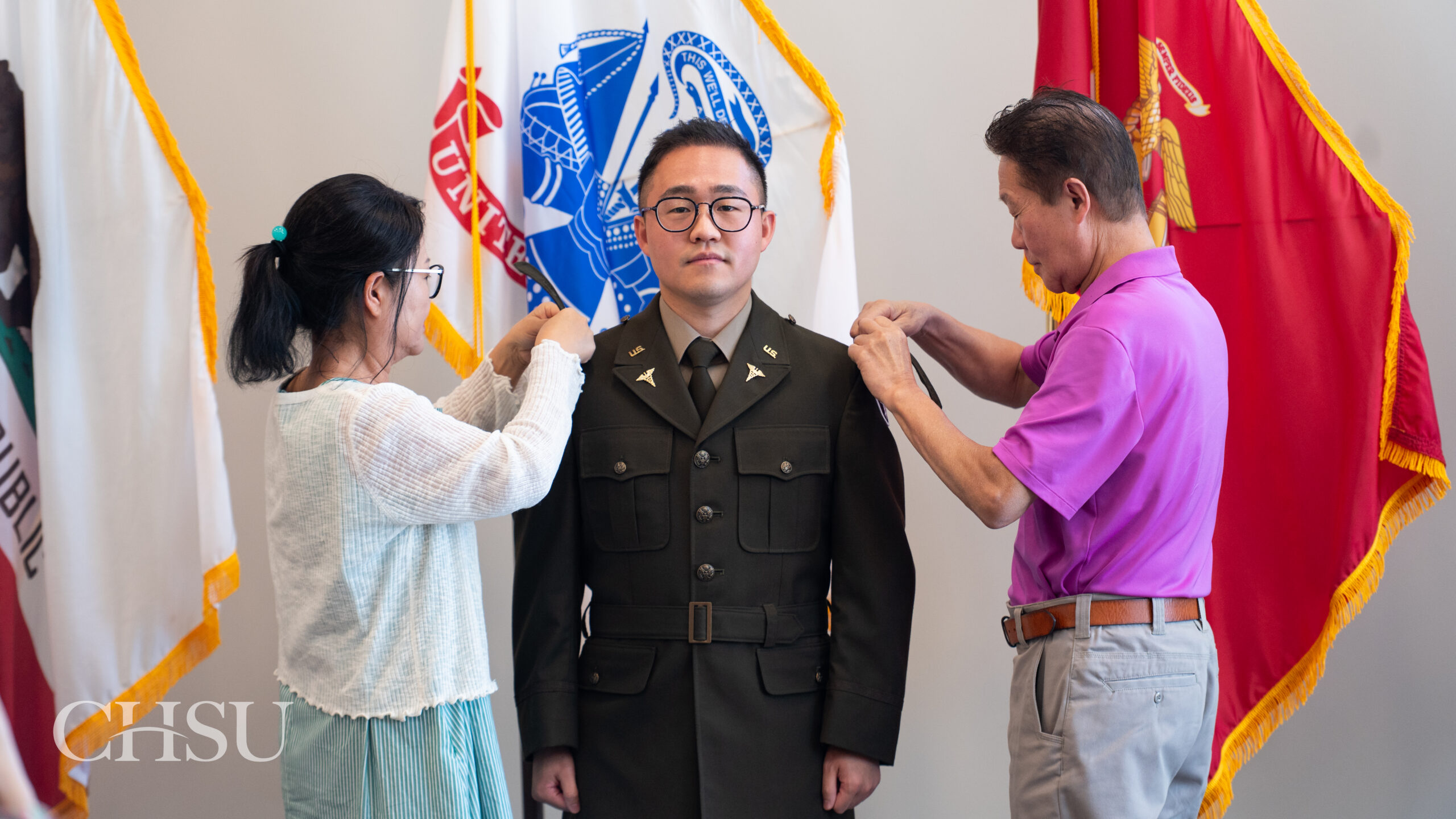 military officer medical graduate having uniform pinned with new rank