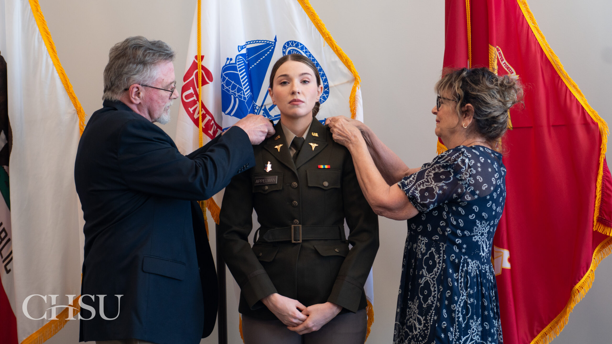 military officer medical graduate having uniform pinned with new rank