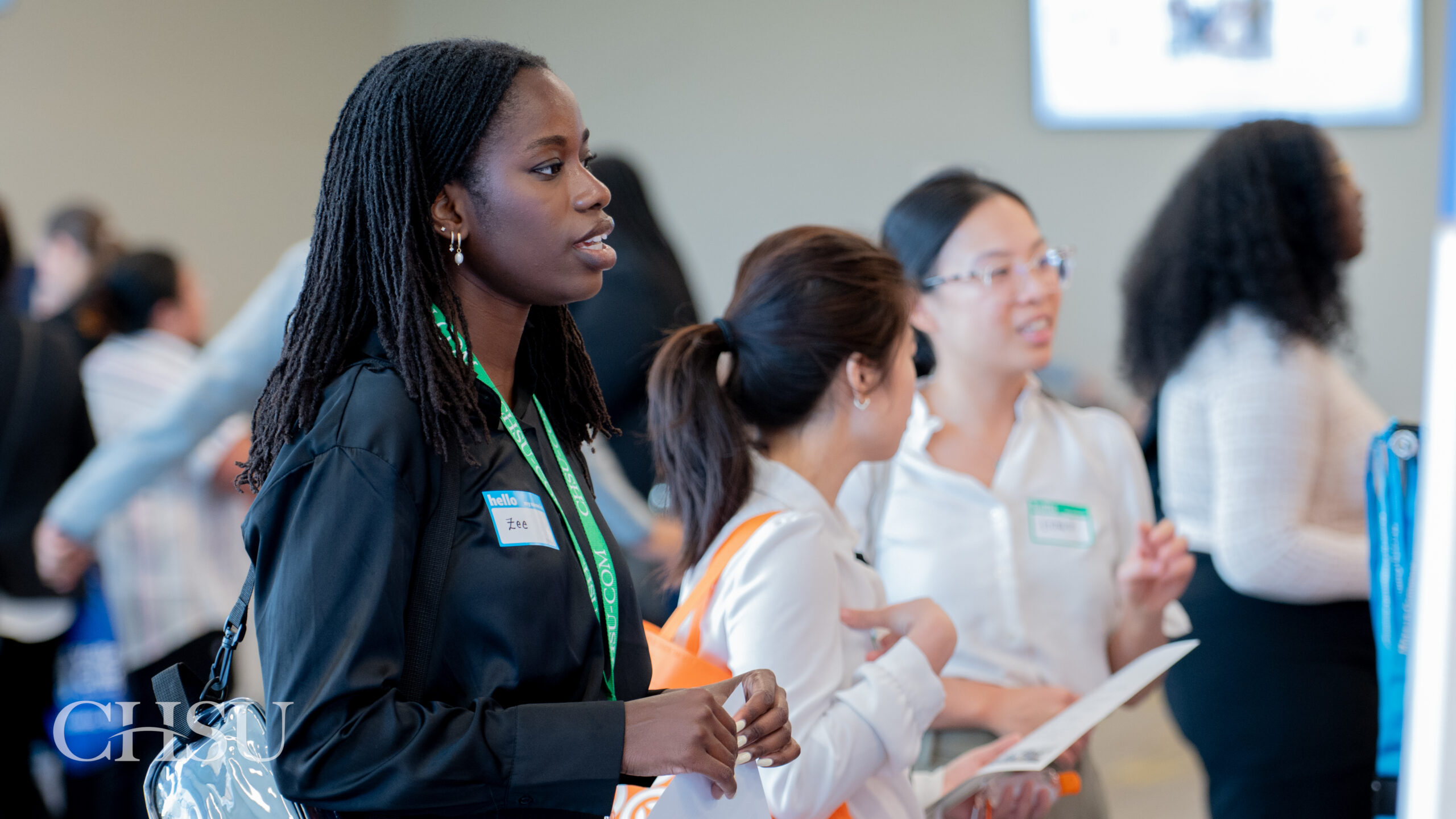 Three CHSU medical students speaking with residency program representatives at the 2026 CHSU-COM Residency Fair.
