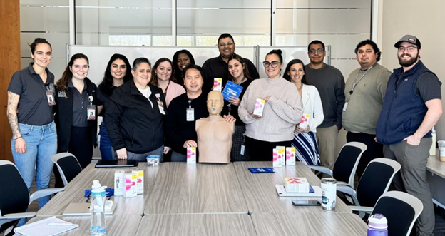people with manikin in group photo