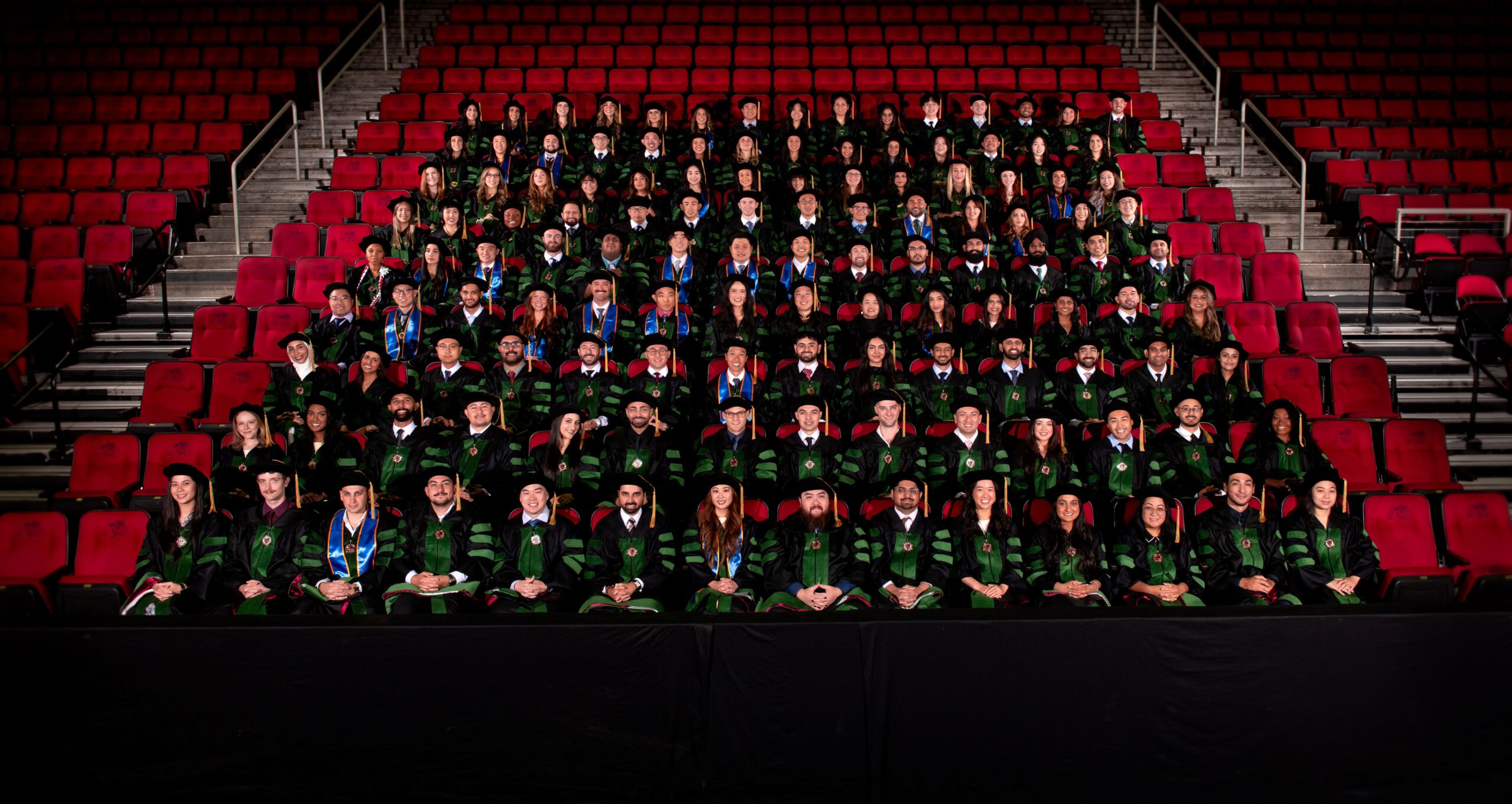 COM Class 2026 Group Photo in regalia, seated in stadium