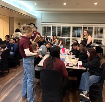 student standing and guiding naloxone administration to seated students