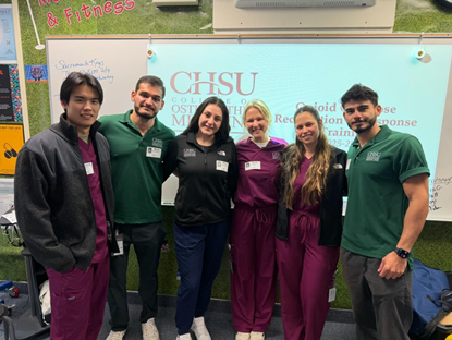 group photo of 6 students in front of presentation screen