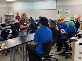 medical students training high school students seated at desks in classroom