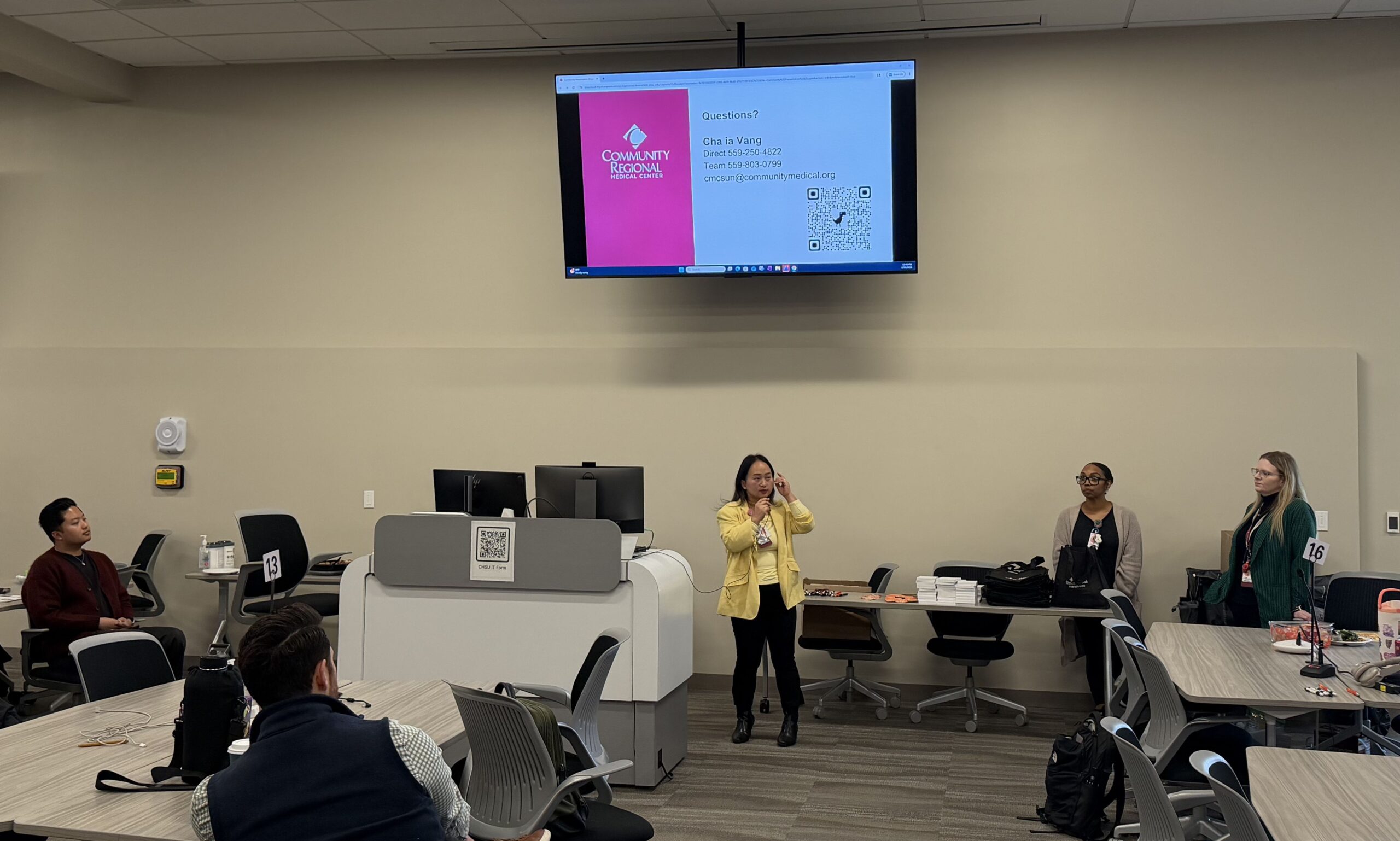 Chaia Vang presenting in classroom with screen above