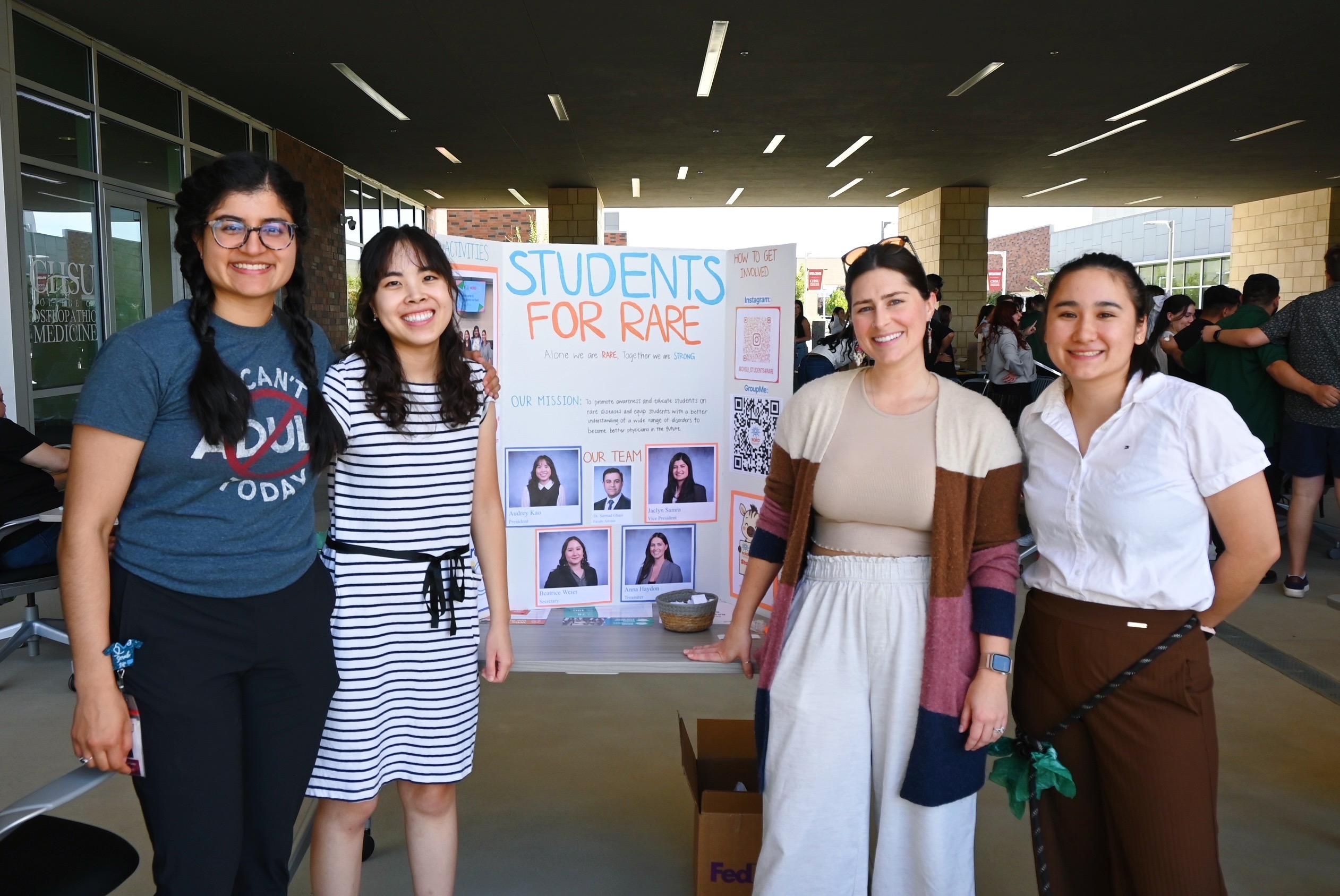 4 students with Student for Rare poster