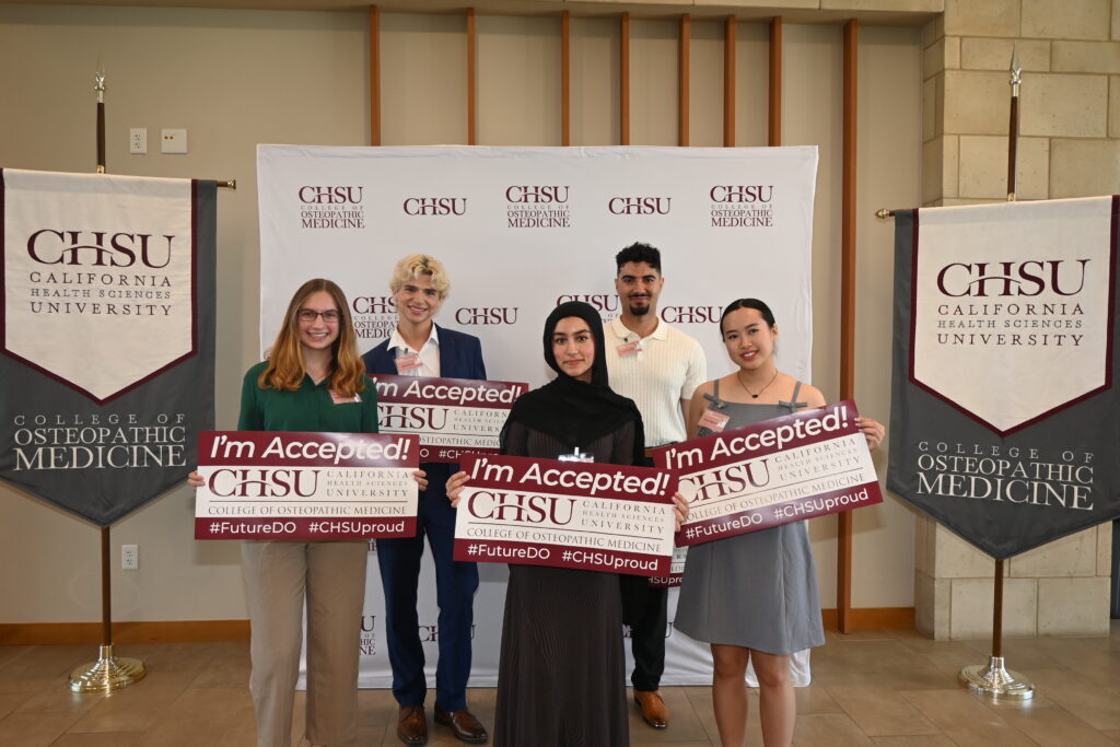 5 students holding I'm Accepted at CHSU-COM signs