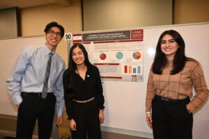 People standing in front of research poster