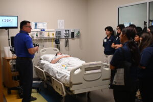 A CHSU physician and faculty member leads a clinical skills demonstration for a group of prospective medical students at the CHSU simulation lab.