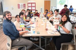 students seated at tables art projects
