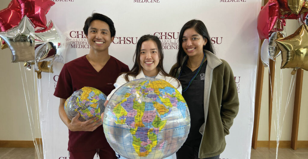 students holding inflatable globe