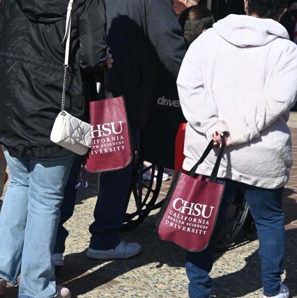 students holding CHSU bags