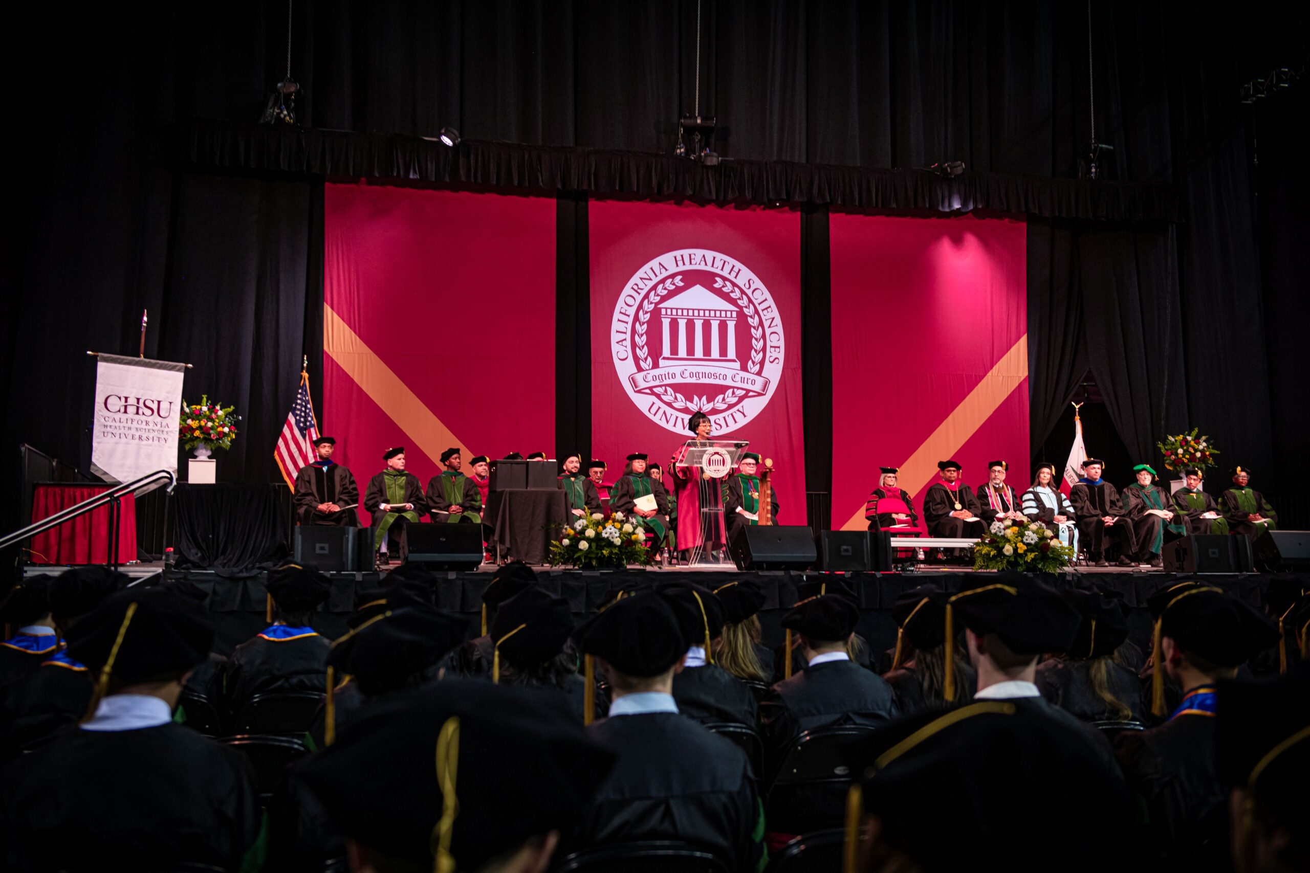 stage with university seal in background at CHSU commencement ceremony