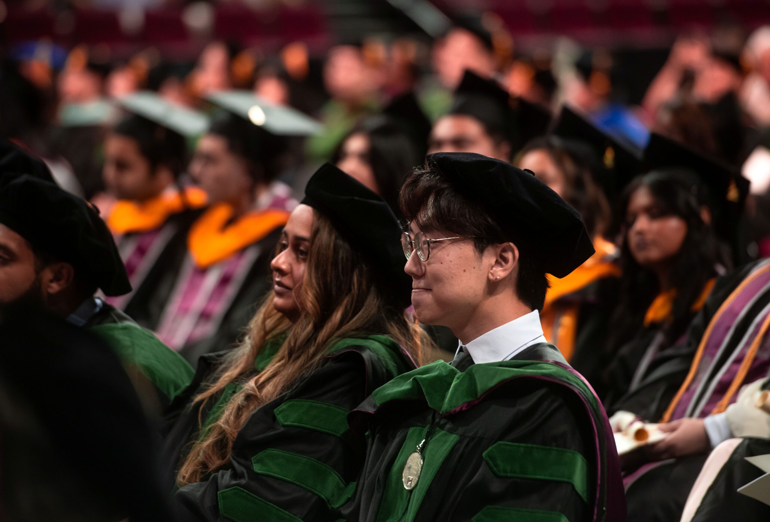 graduates seated wearing regalia at Commencement