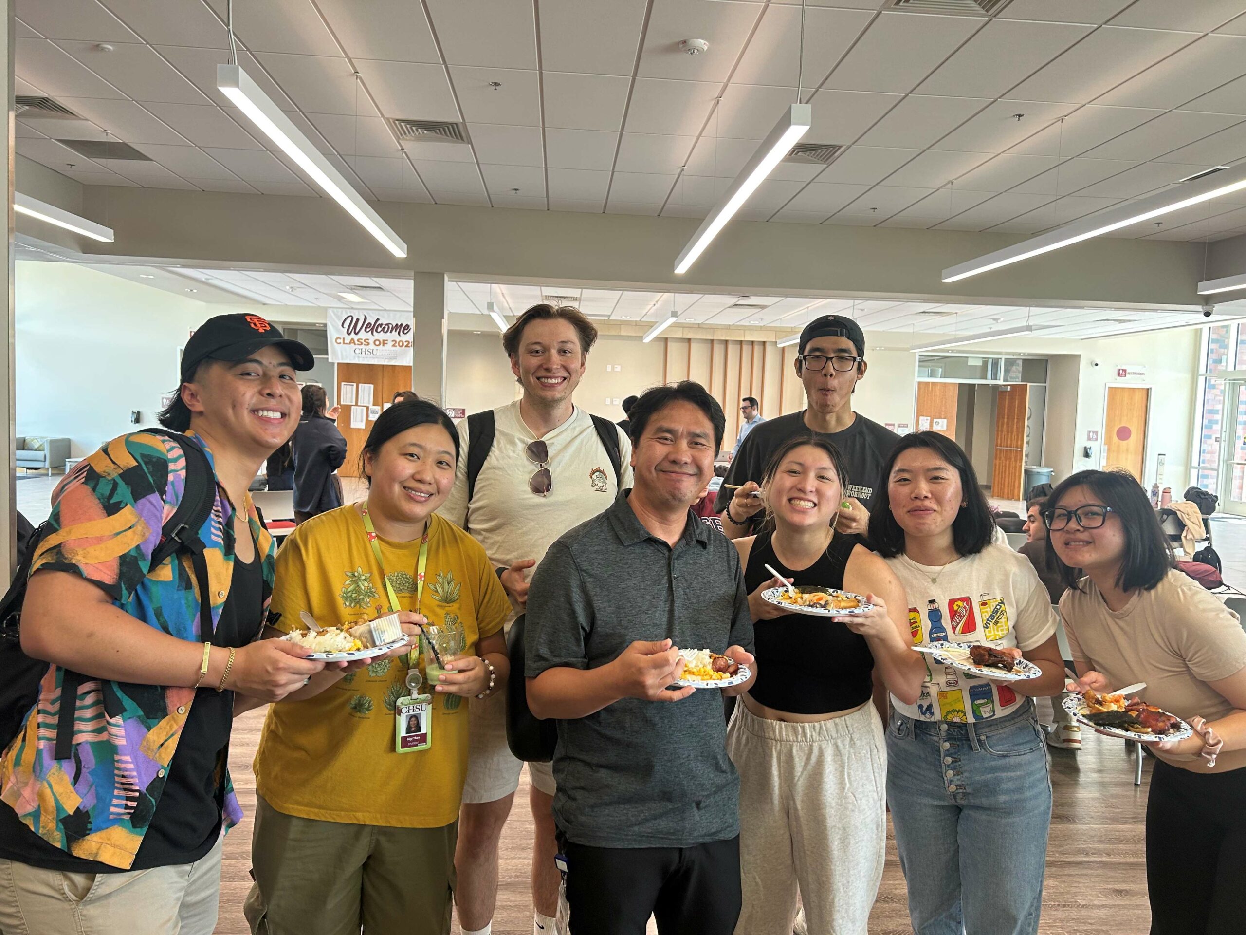 Students and Staff group photo with lunch on plates