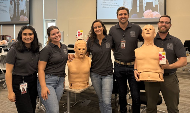 five students with narcan training manikins