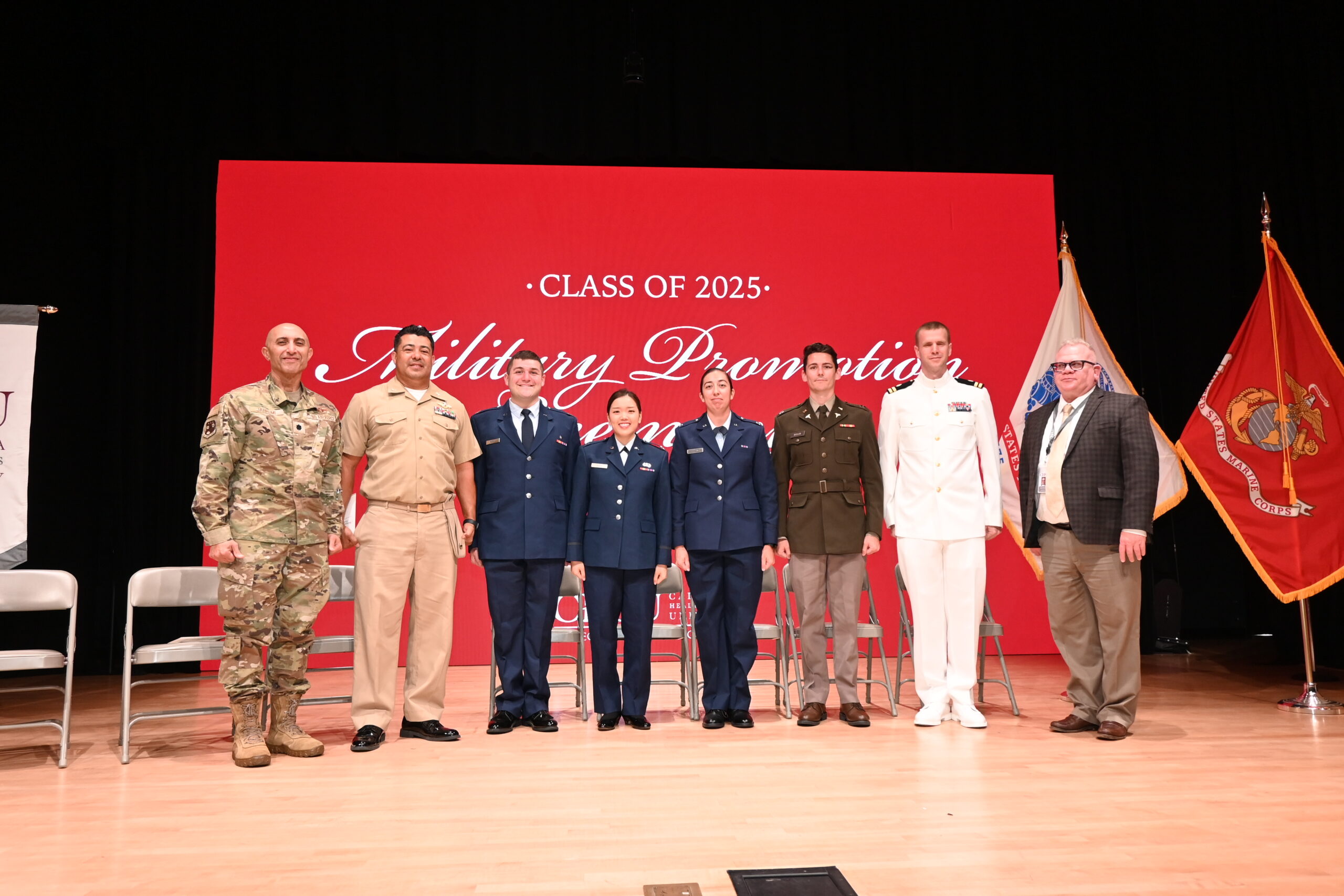 People in Military uniforms and suits on stage