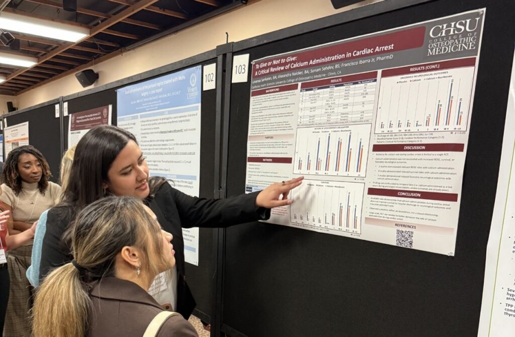 person presenting information from poster to another person