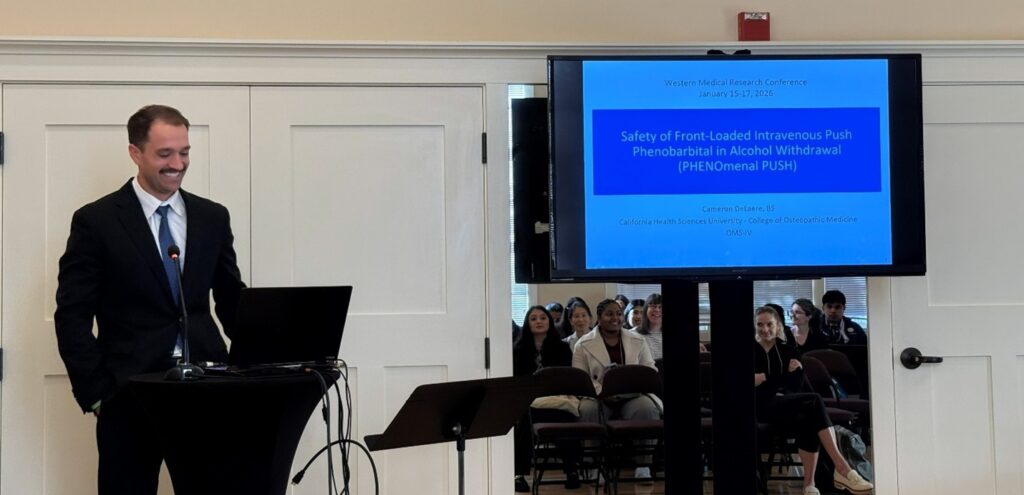 Person giving presentation at podium with information on screen