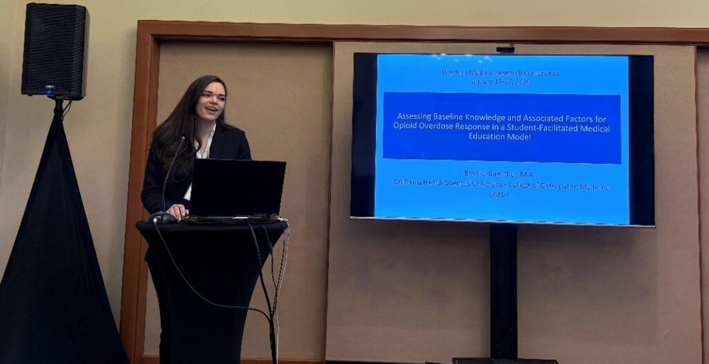 Person giving presentation at podium with information on screen