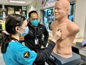 High school ROP student listening to simulated heart