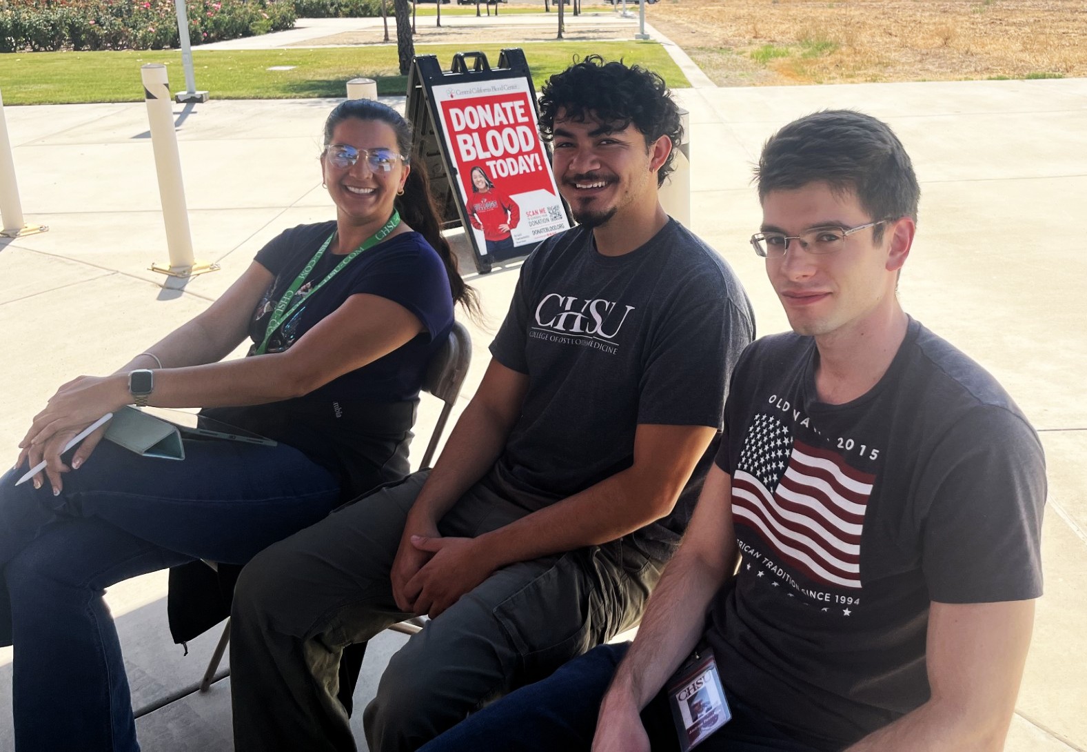 Three CHSU medical students sit together while waiting in line to donate blood during the Central California Blood Center blood drive at CHSU-COM.
