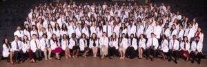 CHSU-COM Class of 2029 medical students in group photo wearing white coats