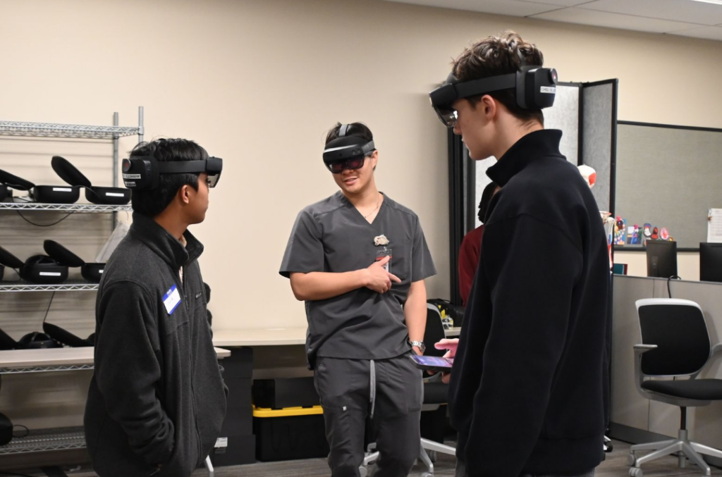 3 students wearing HoloLens devices on their heads 