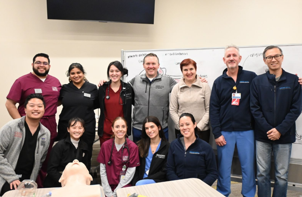 group photo of Kaiser physicians and CHSU students with intubation manikin